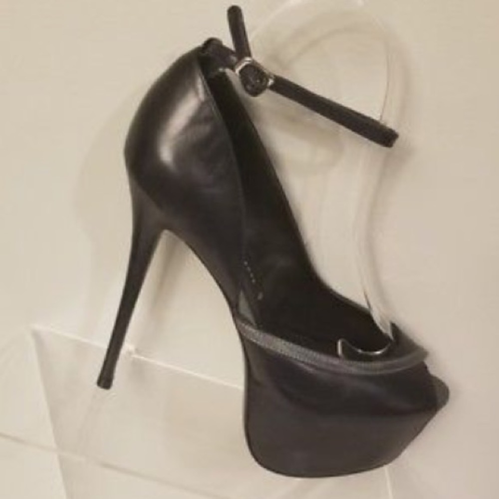 Lightly worn black leather heels.